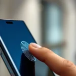 Close-up of person using fingerprint sensor on side of Samsung Galaxy smartphone, finger touching metallic sensor, modern minimalist background