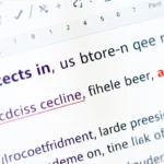 Close-up of Microsoft Word document showing formatting marks visible with section break symbols displayed as double-line breaks with labels, computer monitor screen
